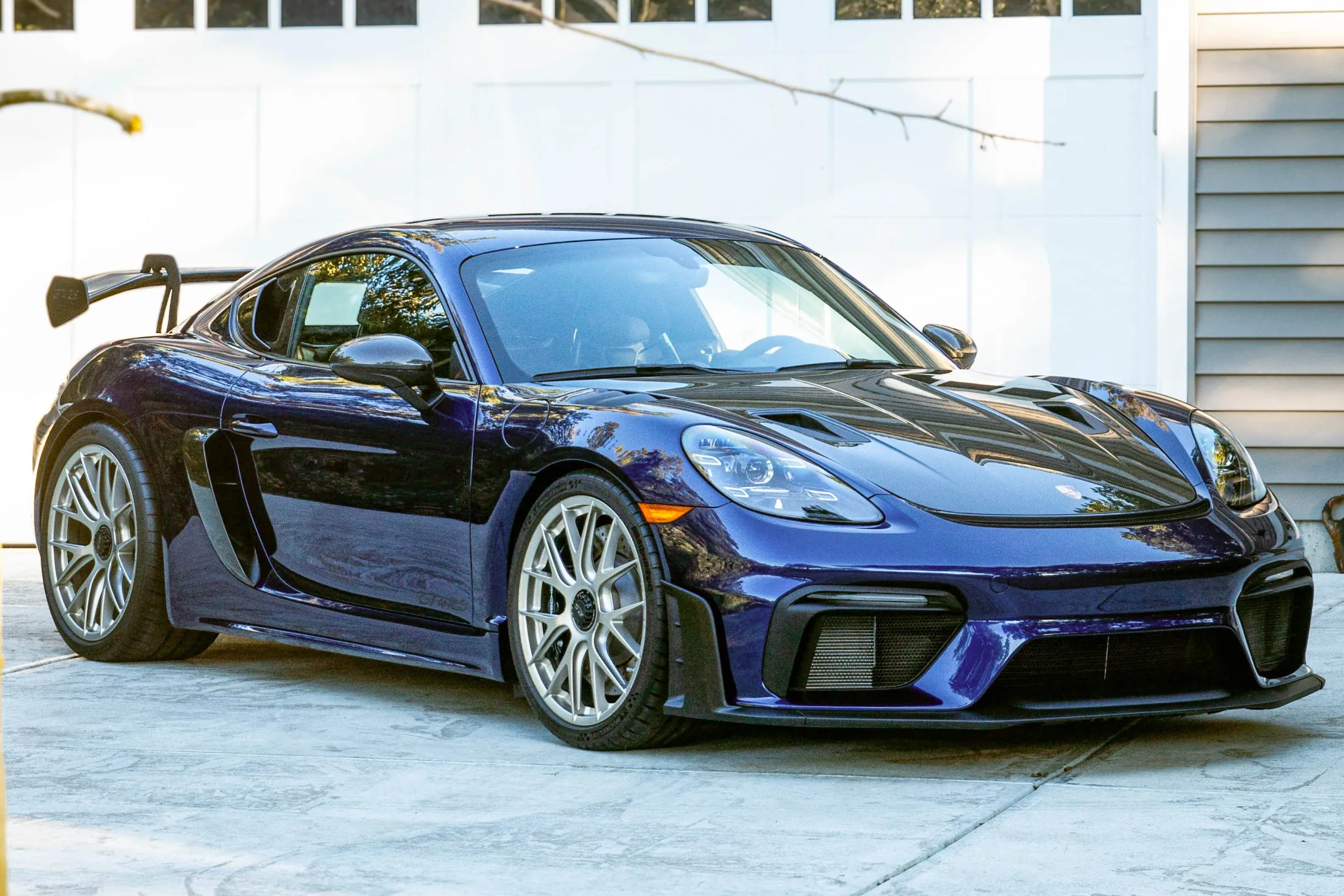 Freshly detailed Porsche Cayman GT4 in a customer driveway
